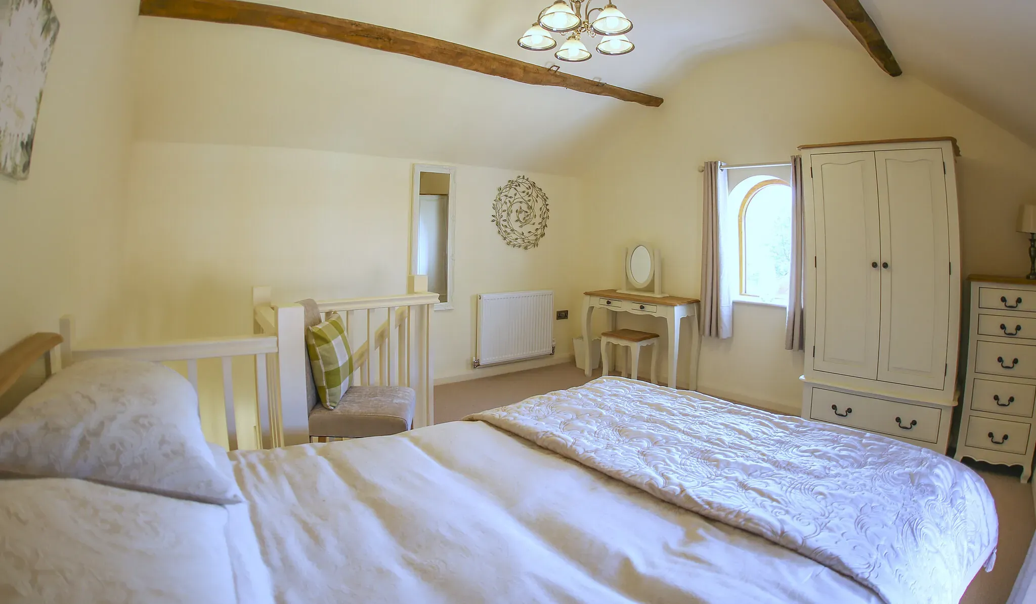 Chestnut Barn second bedroom with a double bed under the beamed ceiling