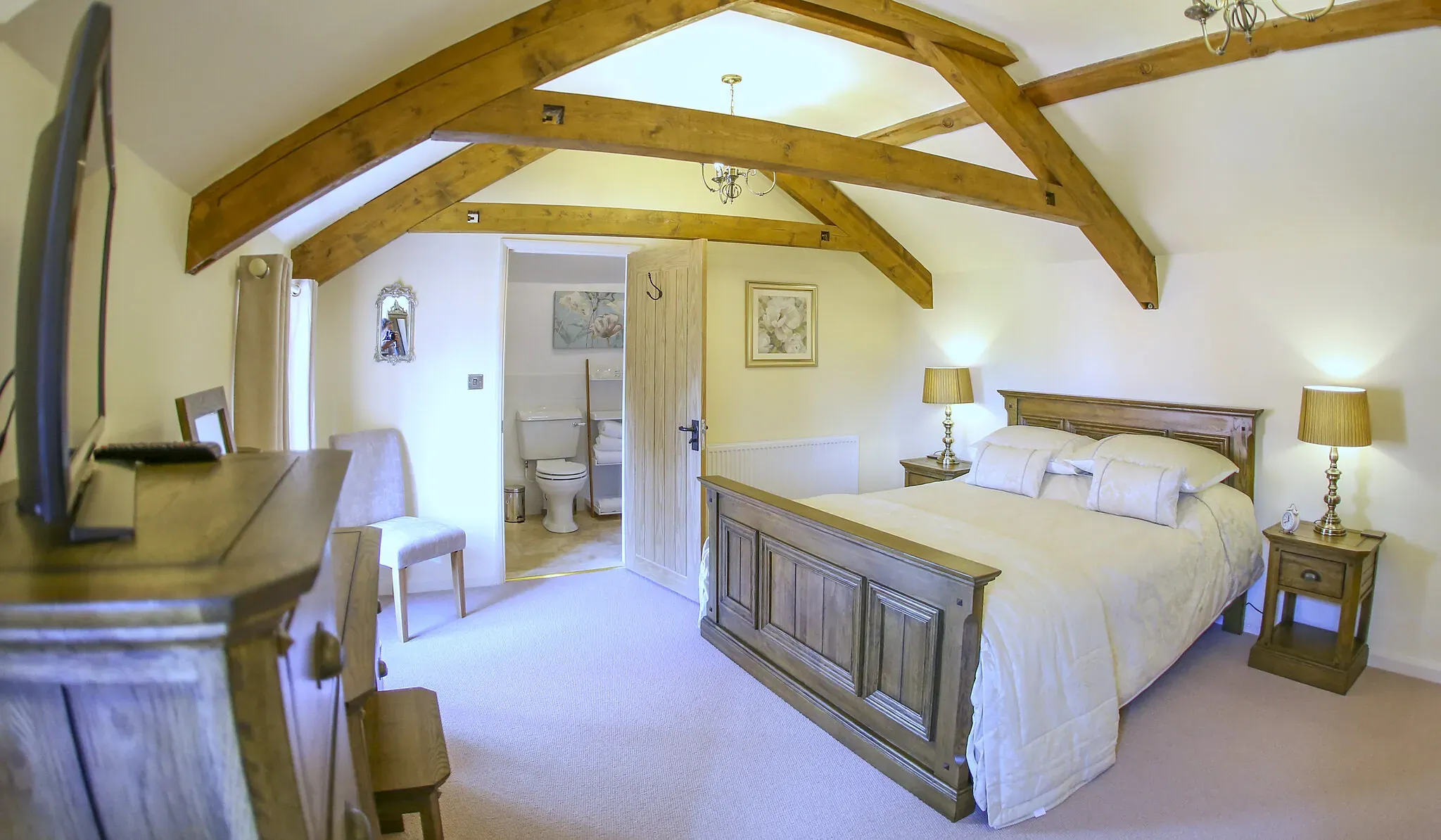 Second view of the Oak Barn master bedroom with dressing table and window